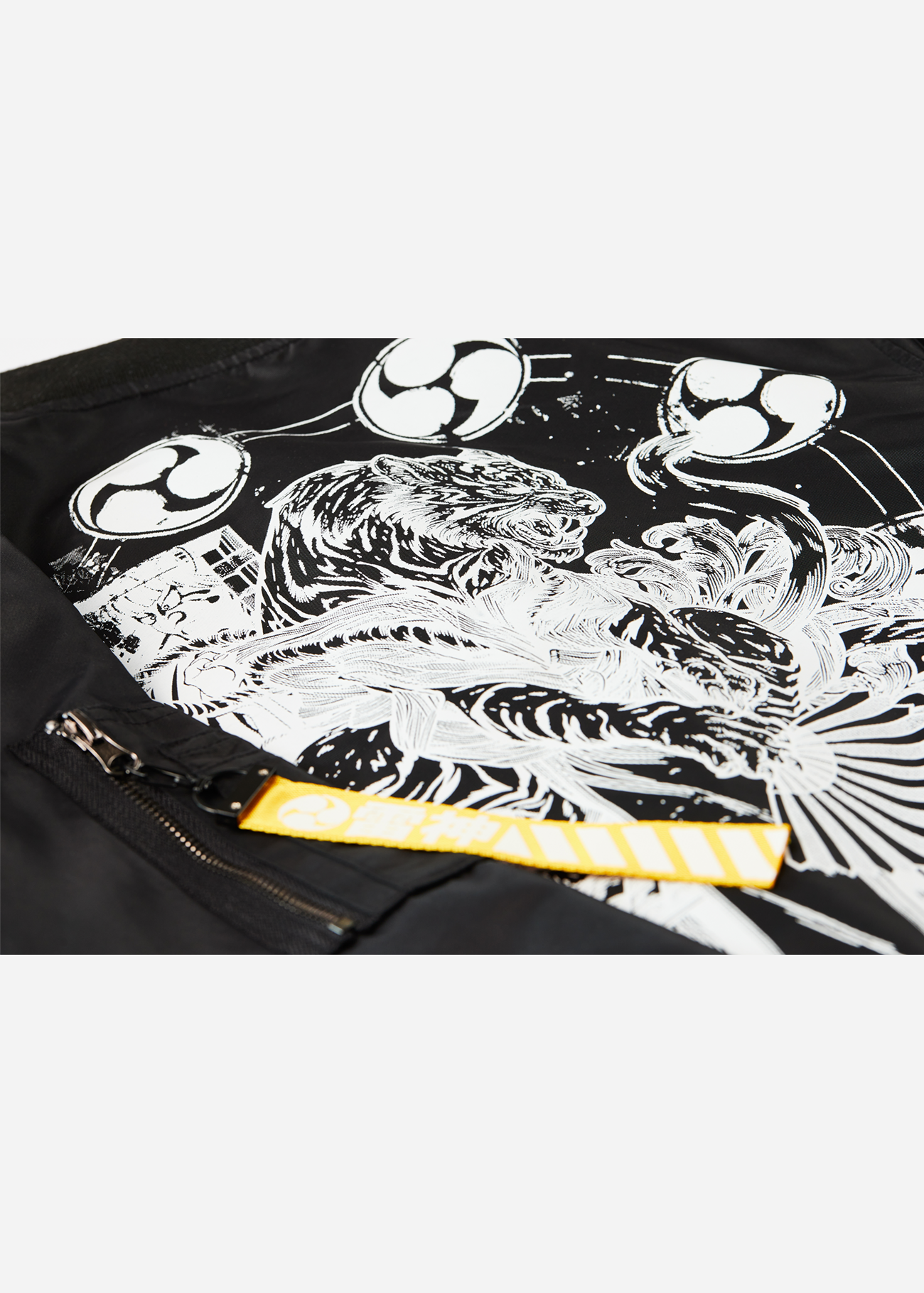 Close up photo of the back of a Black Bomber Jacket featuring Raijin, a Japanese Mythology Figure converted to an anime inspired bomber jacket
