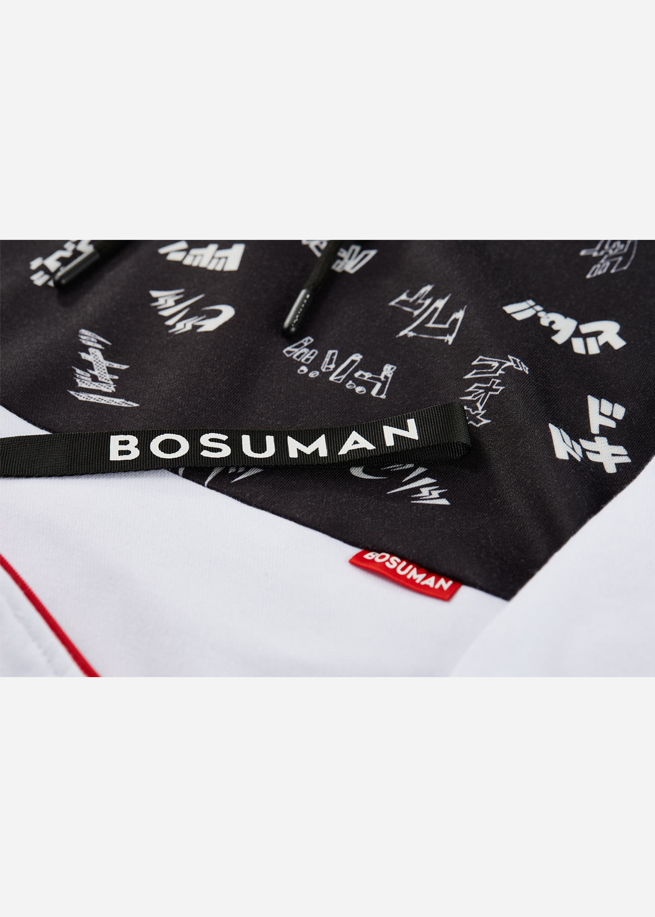 Close up photo of an anime hoodie with manga SFX scattered all over it, black and white anime clothing