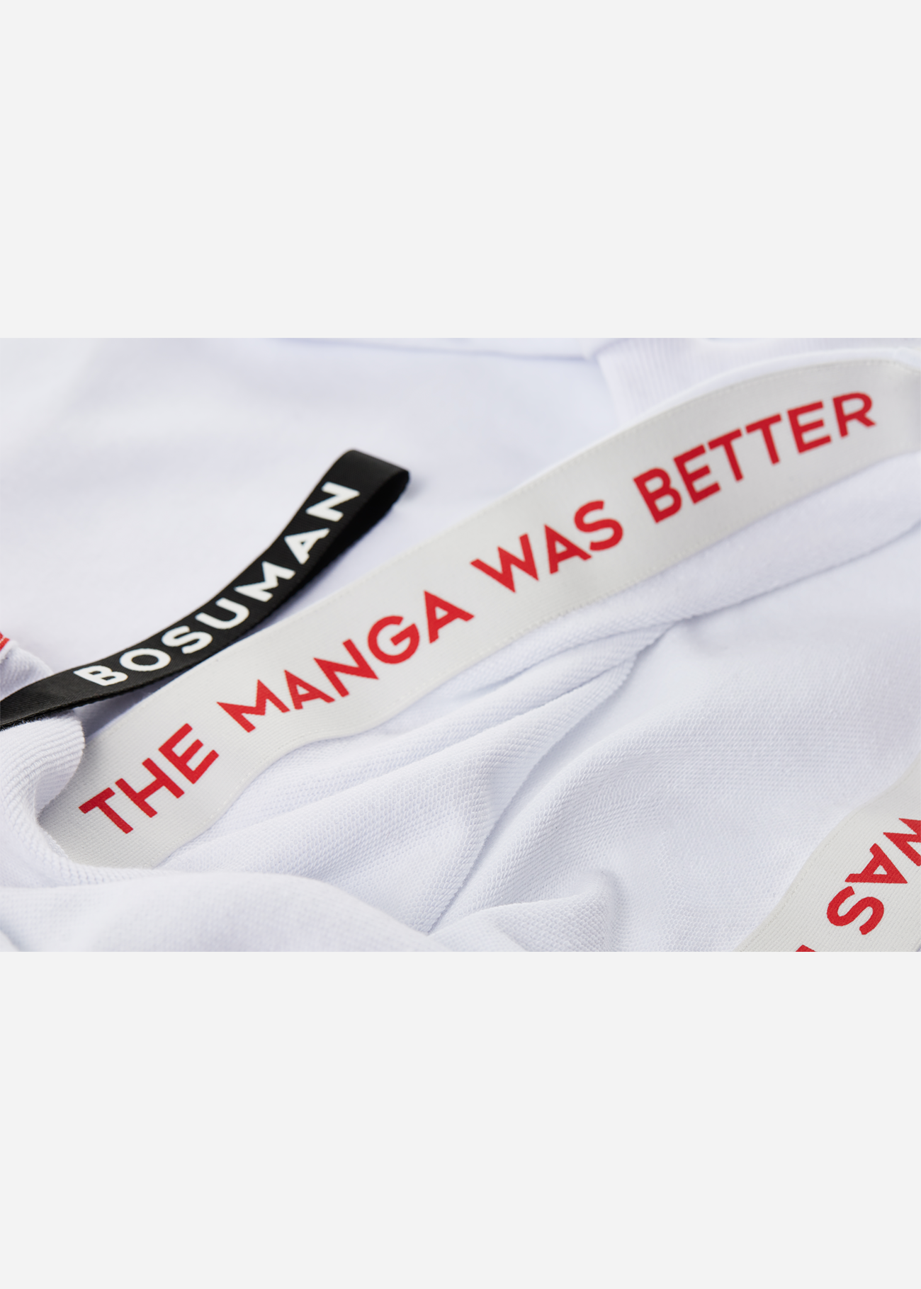 Close up photo of the inside lining of an anime hoodie with manga SFX scattered all over it, black and white anime clothing