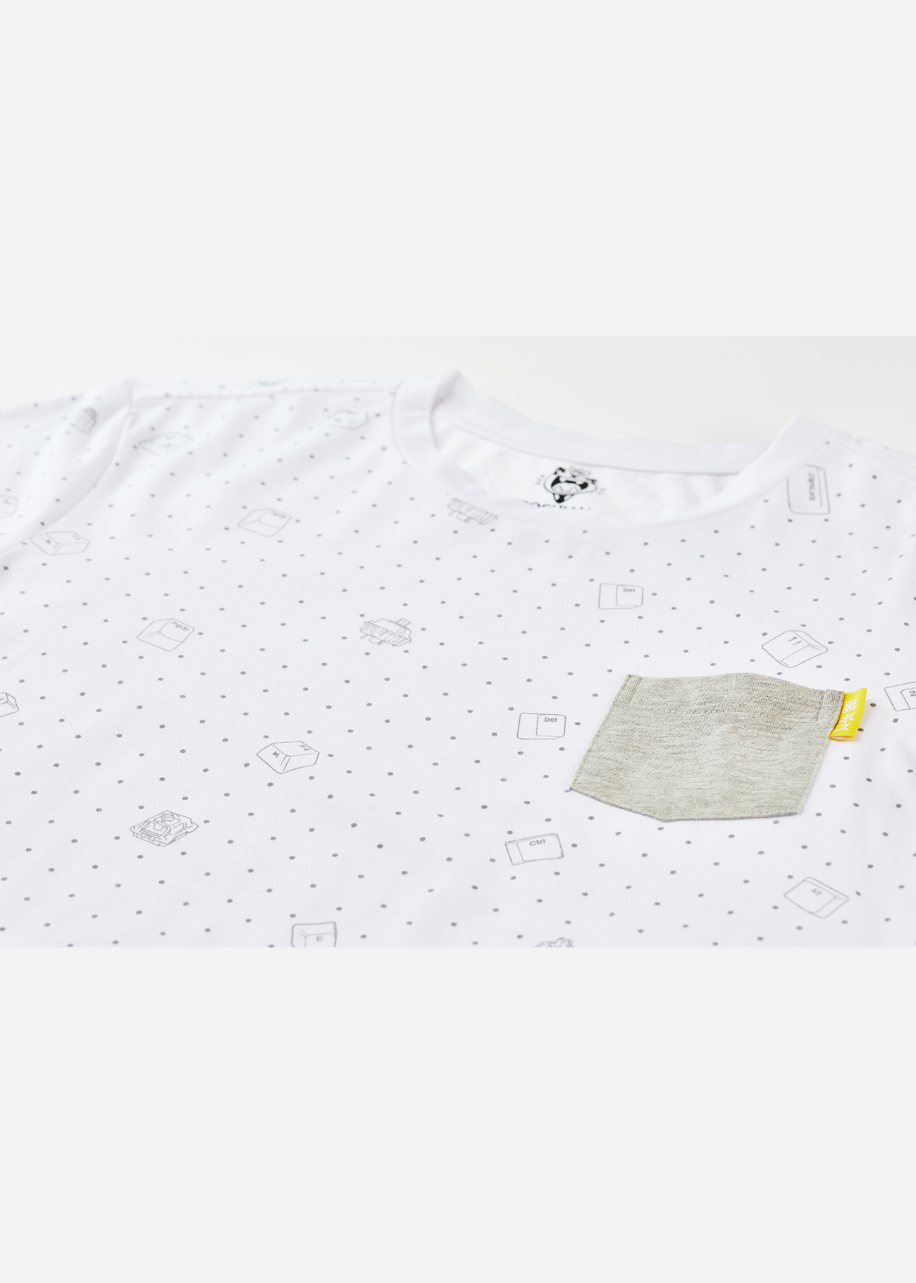A photo of the all over keycap print on a pocket tee shirt
