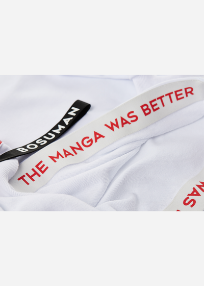 Close up photo of the inside lining of an anime hoodie with manga SFX scattered all over it, black and white anime clothing
